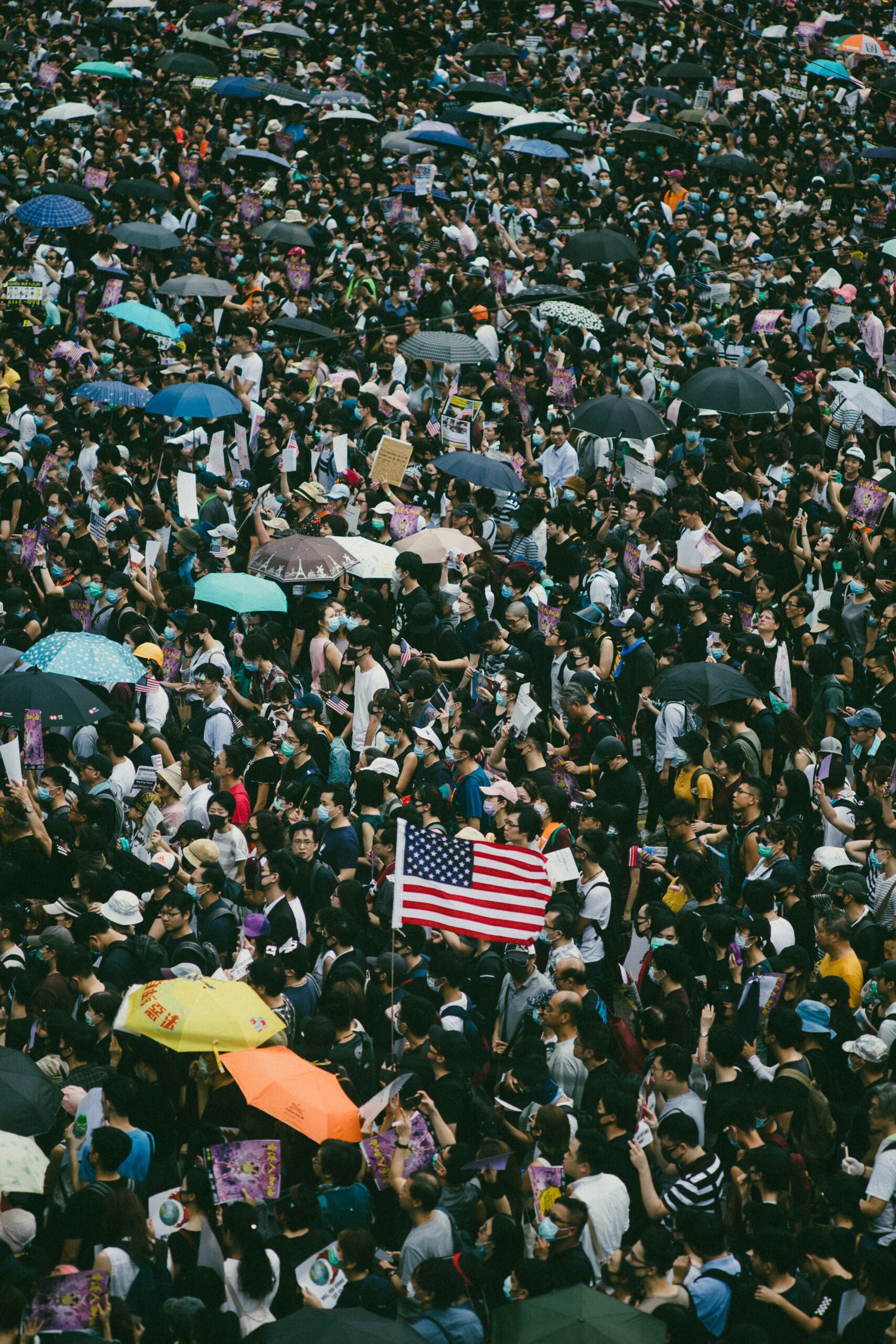 Photo of a crowd and American flag by Joseph Chan on Unsplash
